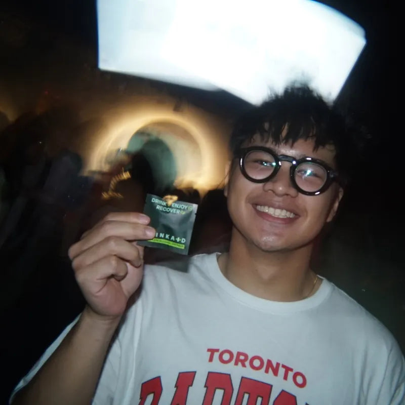 Aaron G holding DrinkAid Complete Alcohol Defense during a night out.